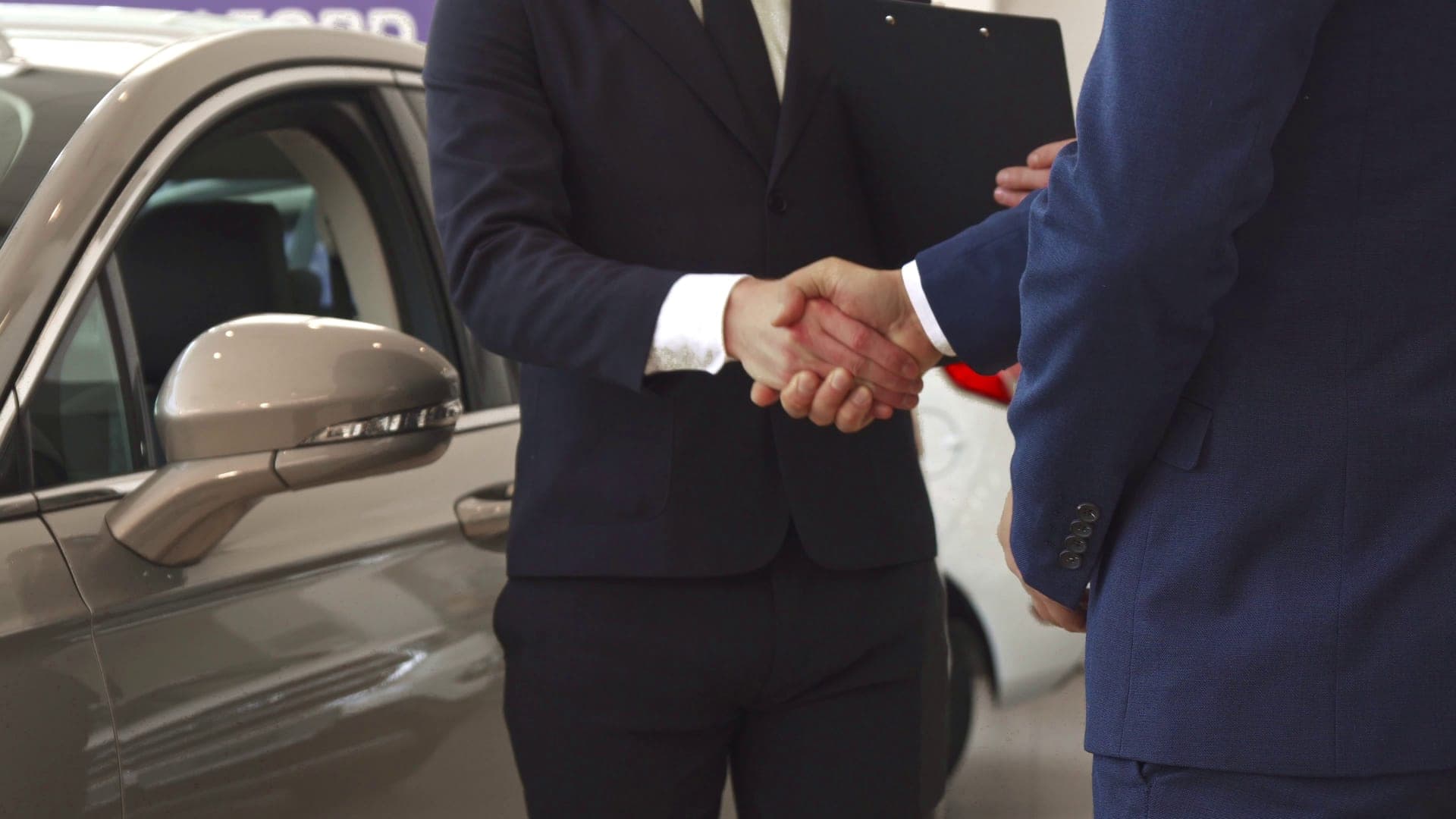 Car dealership handshake on auto loan