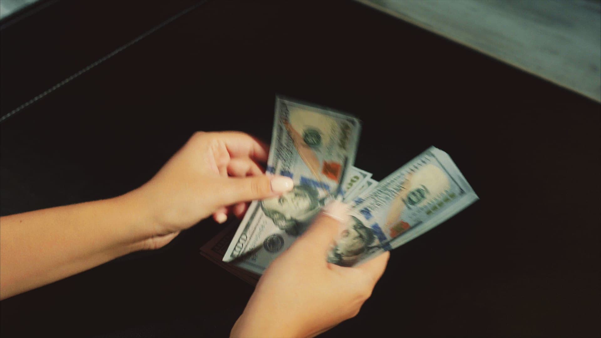 Cash being counted beside financial notes.