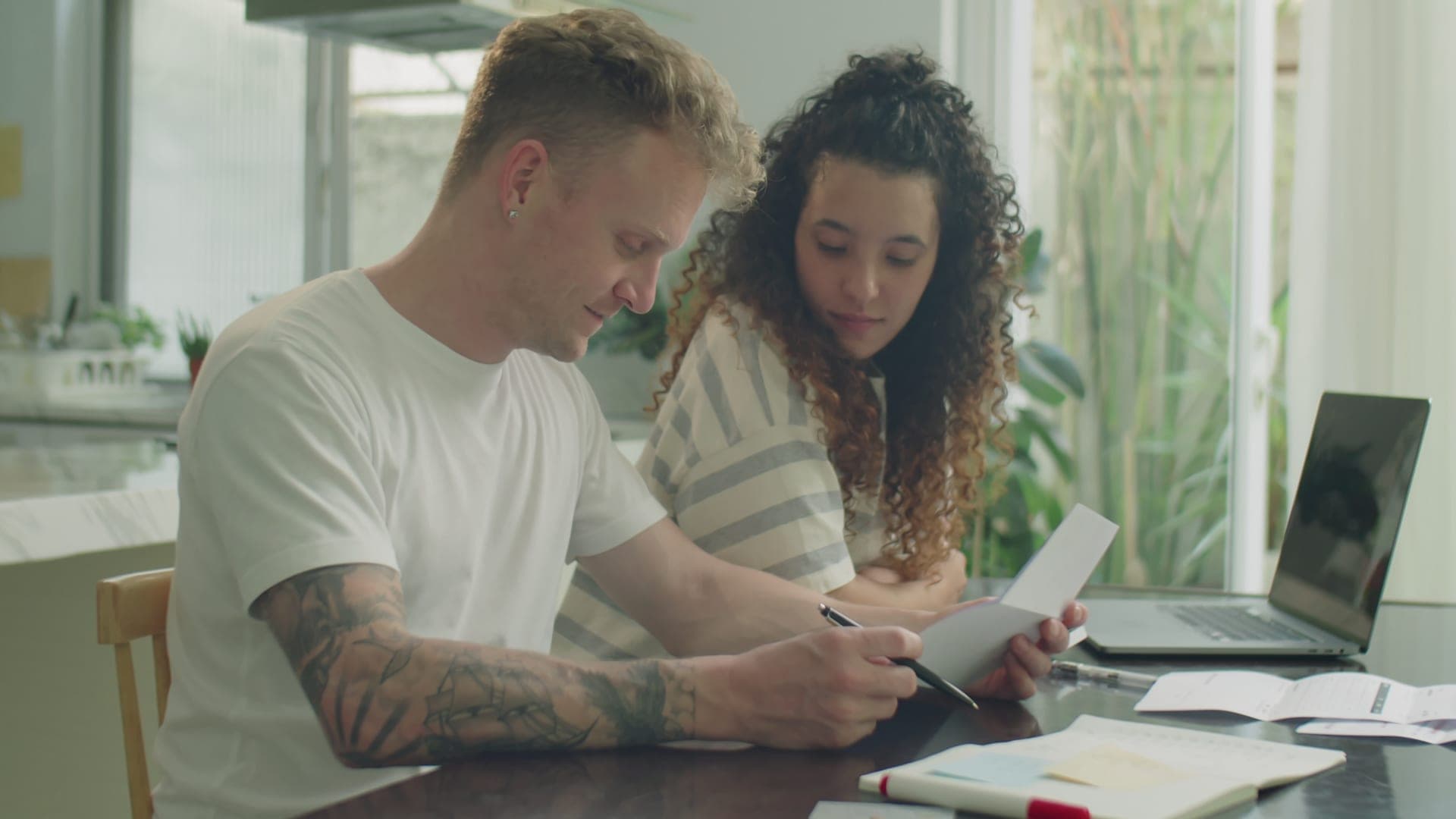 Young couple discussing bills and finances together