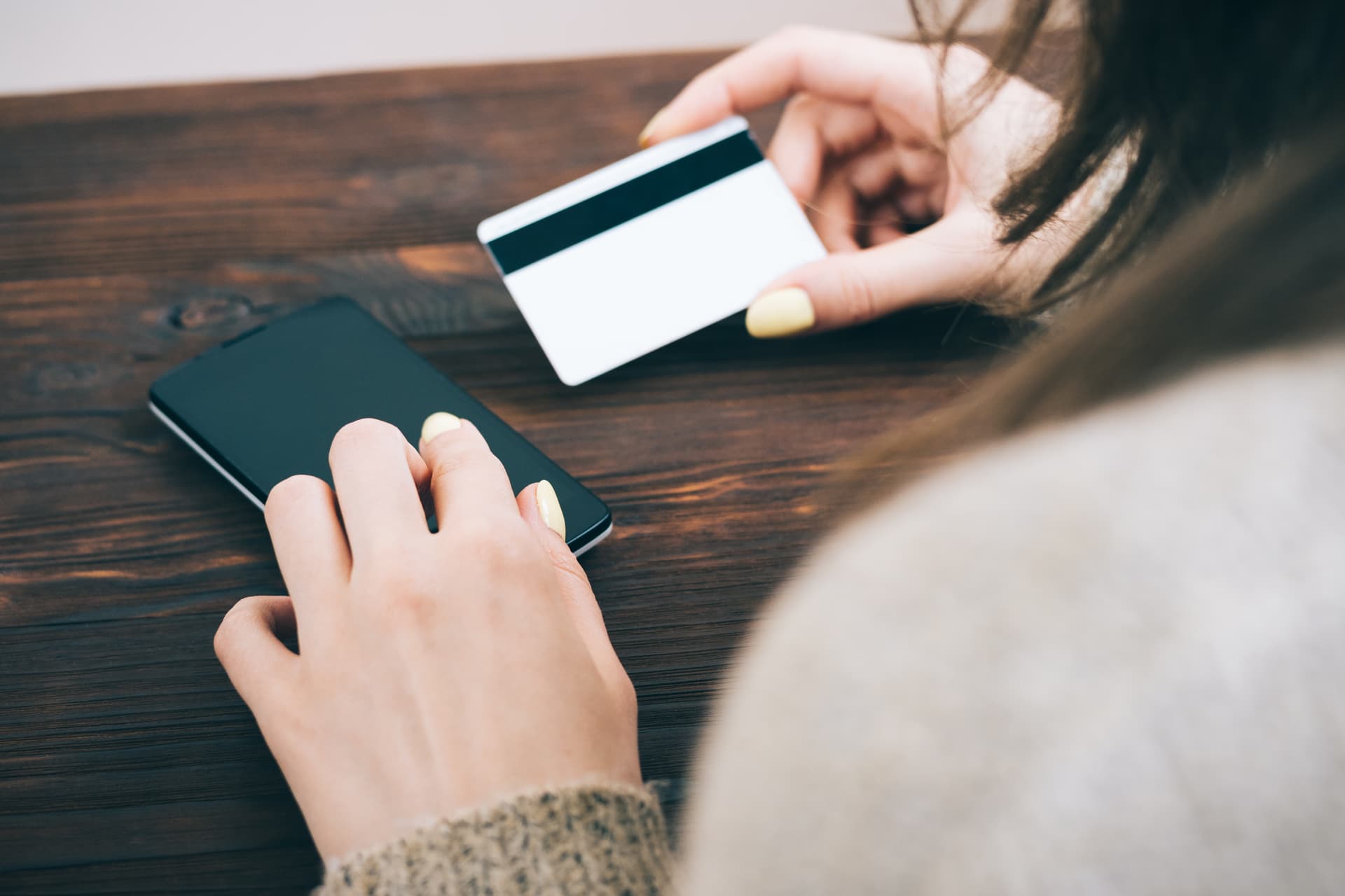 Woman entering credit card information on smartphone