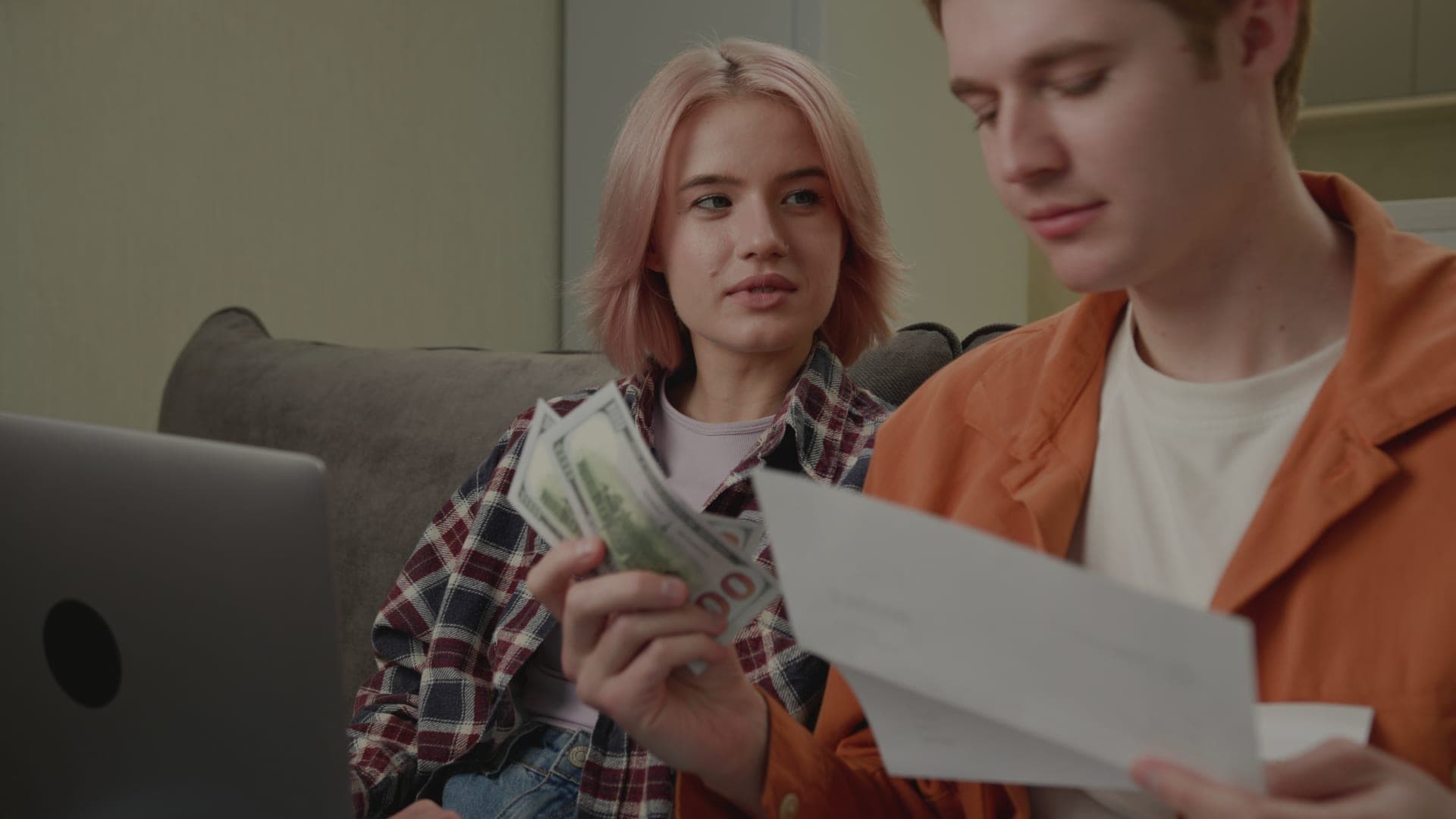 Young family managing paperwork and paying bills together