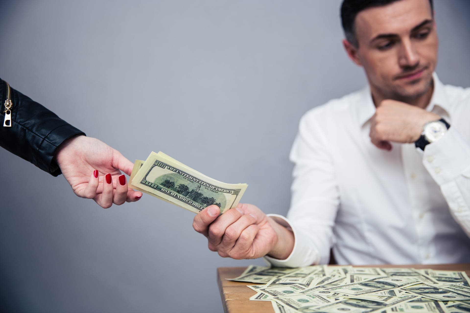 Person handing over money, representing common money mistakes