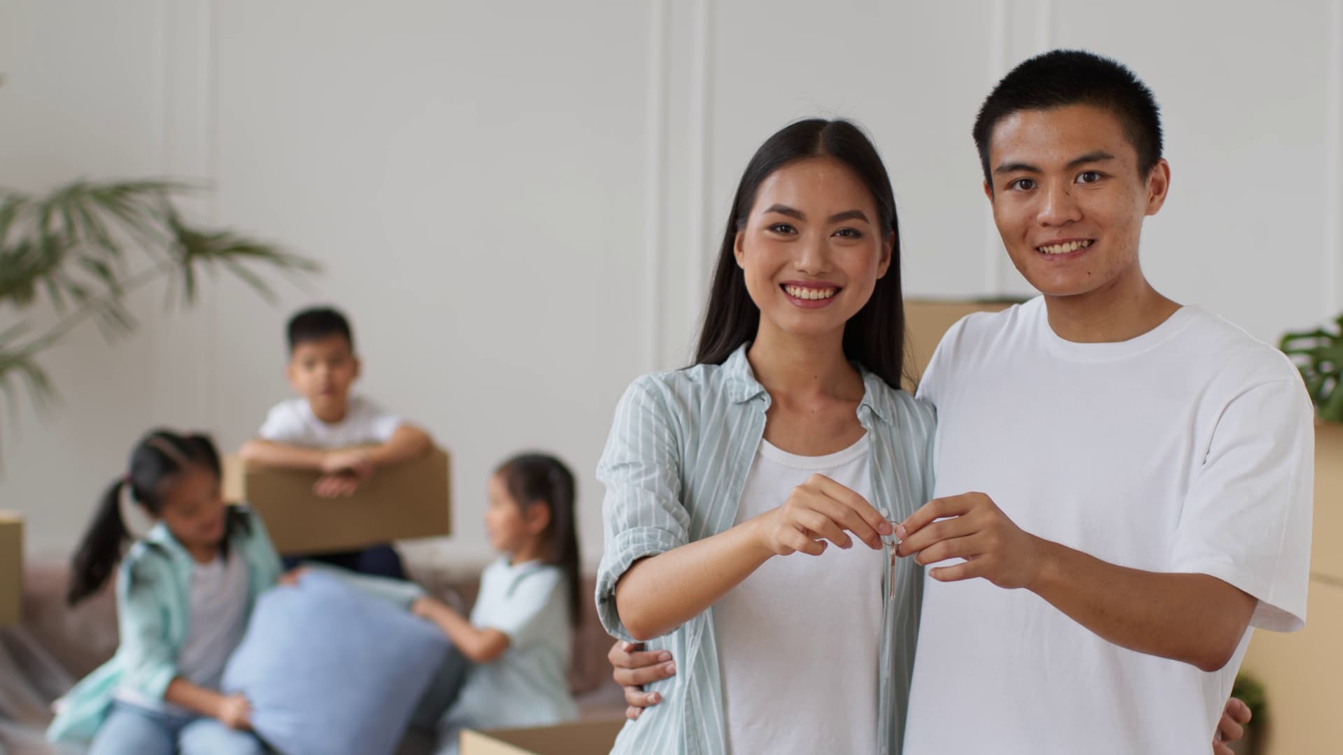 Happy couple holding keys to their new home