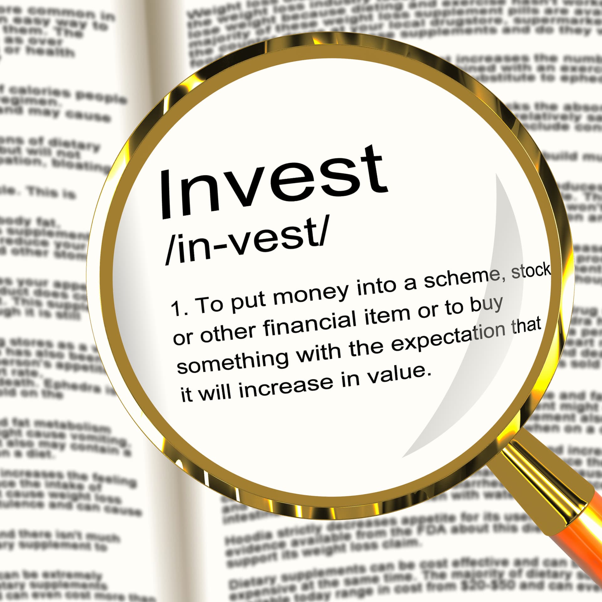 Magnifying glass showing the definition of Invest