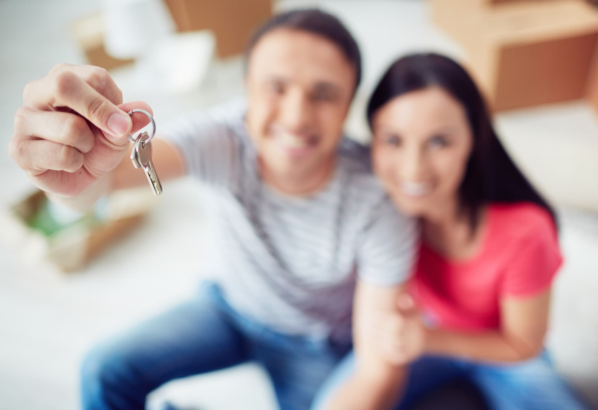 Happy couple holding keys to their new home