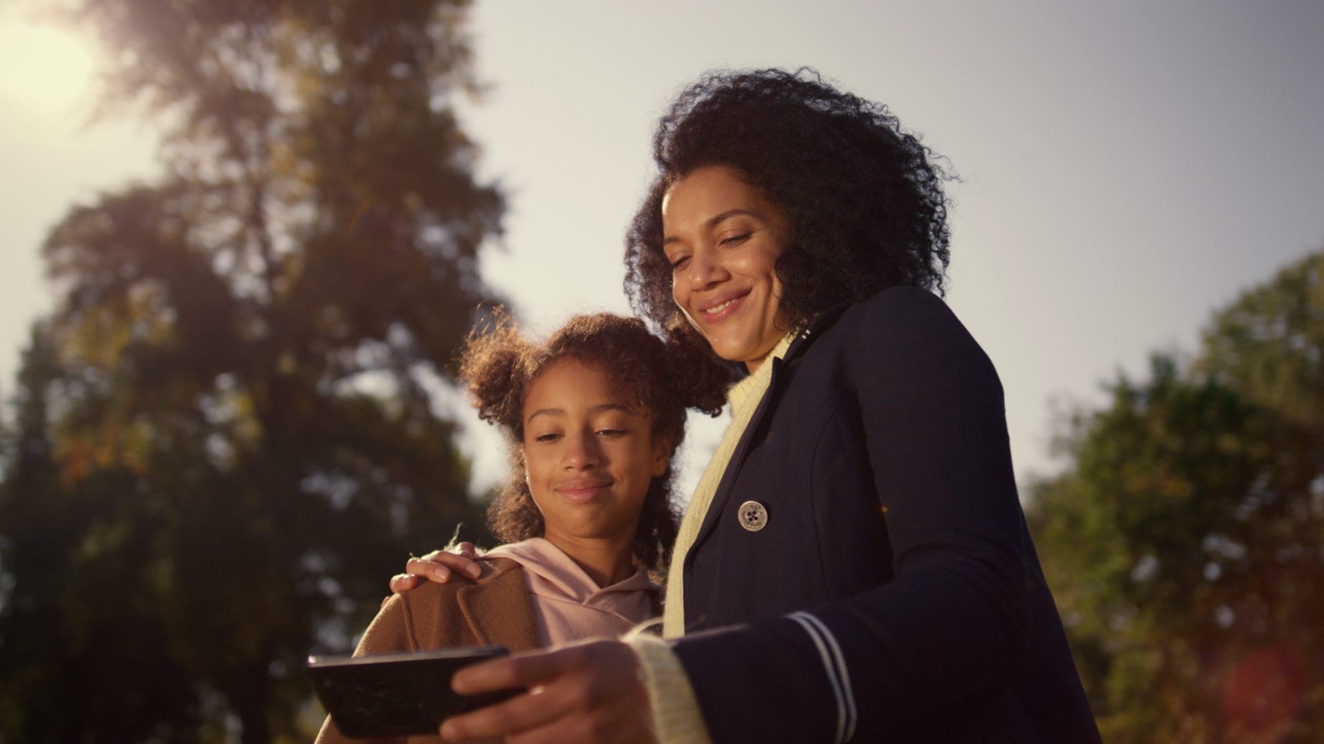 A mother and daughter smiling together.