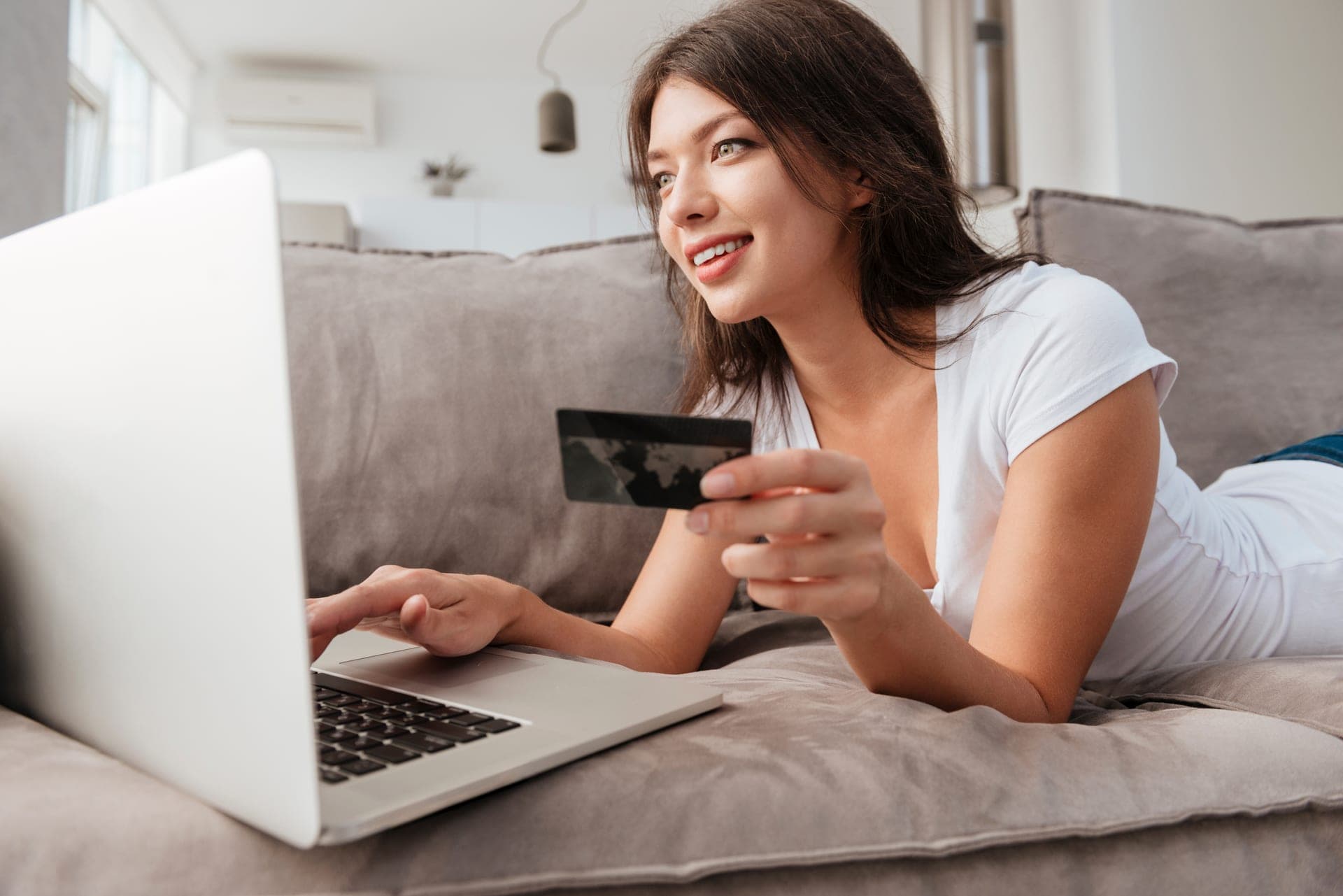 Woman checking credit report with laptop