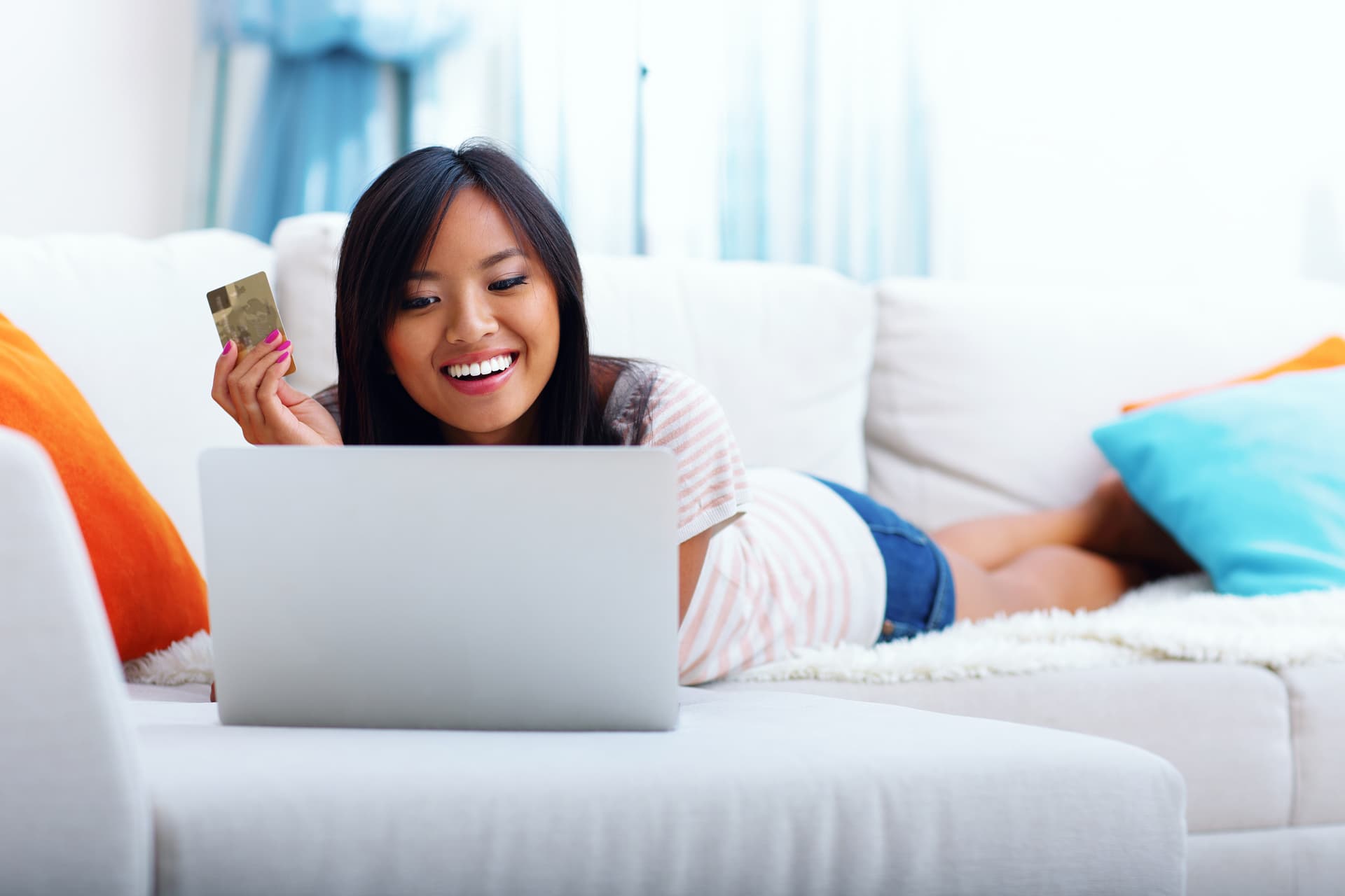 Woman shopping online with credit card rewards