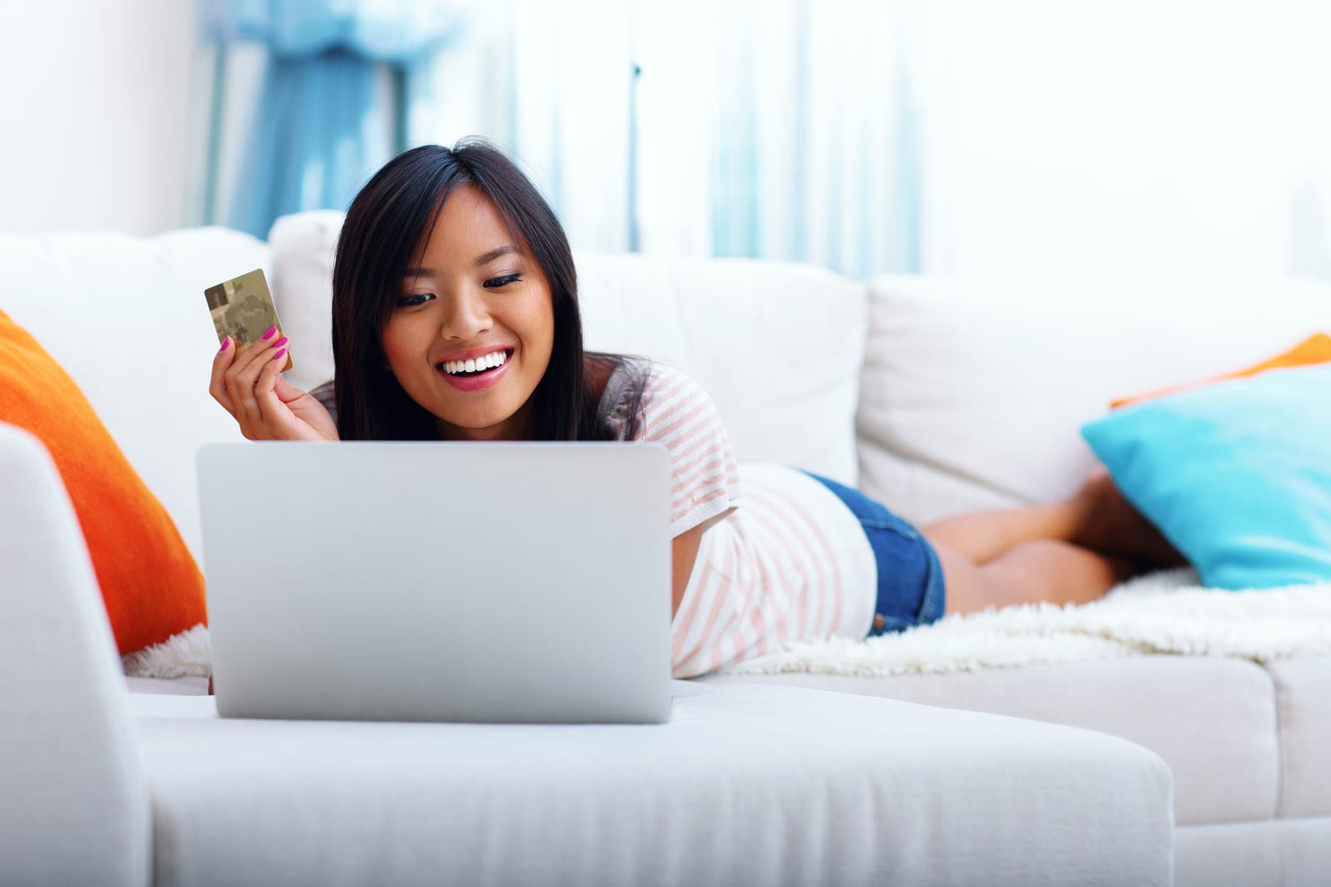 Woman shopping online with credit card rewards