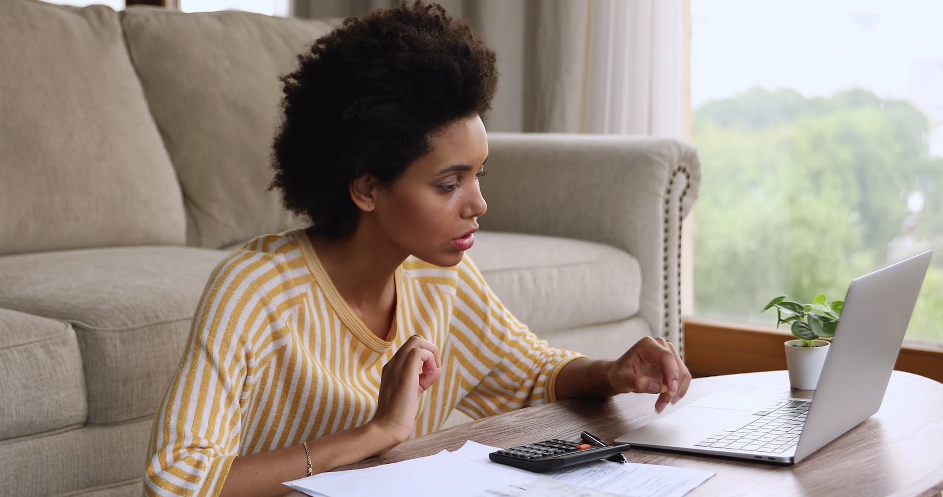 Woman calculating bills and utility payments